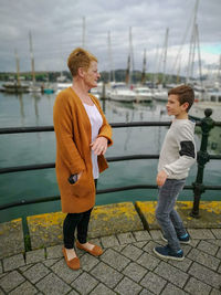 Side view of boy standing by water