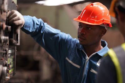 Rear view of man standing in factory