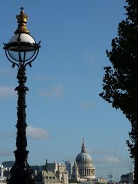 Low angle view of st paul's, cathedral london against blue sky