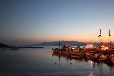 Boats in marina at sunset