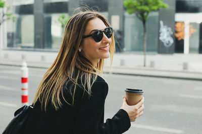 Young woman drinking coffee cup