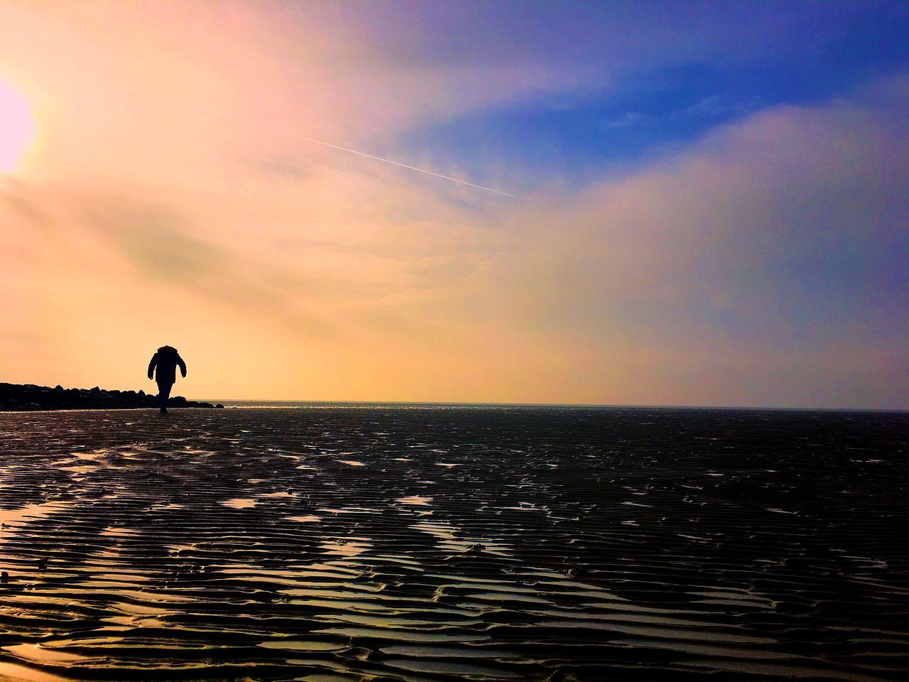 SILHOUETTE MAN ON BEACH AGAINST SKY DURING SUNSET