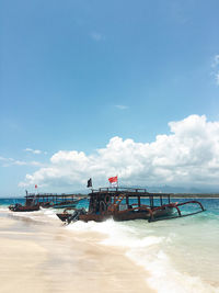 Scenic view of beach against blue sky