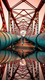 People on bridge against sky