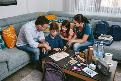 High angle view of parents looking at document