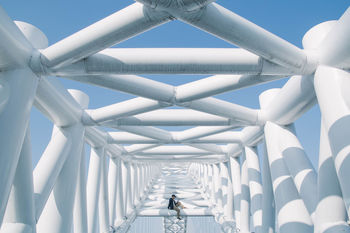 REAR VIEW OF WOMAN ON WALKWAY