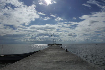 Pier over sea against sky