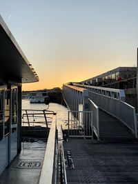 Pier over sea against clear sky during sunset