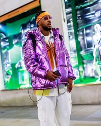 Portrait of young man standing in city