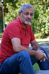 Portrait of man sitting in park