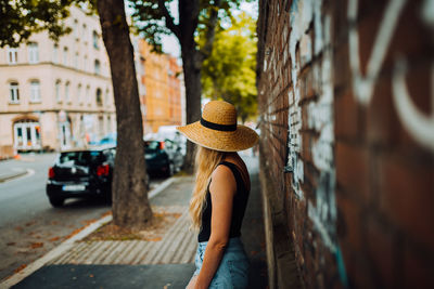 Rear view of woman wearing hat on street