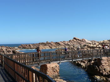 Scenic view of sea against clear blue sky