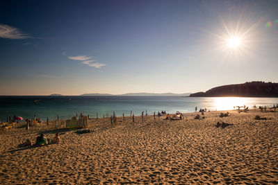 Scenic view of beach against sky during sunset