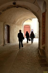 Full length of woman walking in tunnel