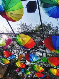 Low angle view of colorful balloons against sky