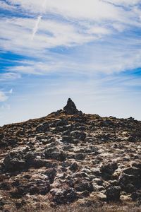 Rock formations on landscape against sky