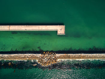 Built structure by lake against wall