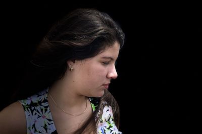 Close-up portrait of a teenage girl looking away