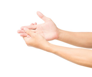 Close-up of human hand over white background