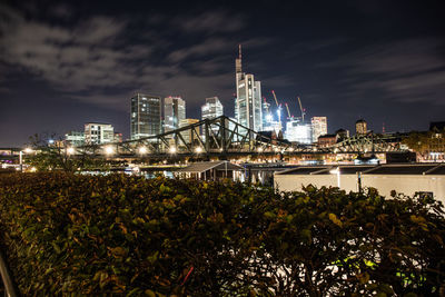 Illuminated buildings against sky at night