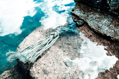 High angle view of rock on sea shore