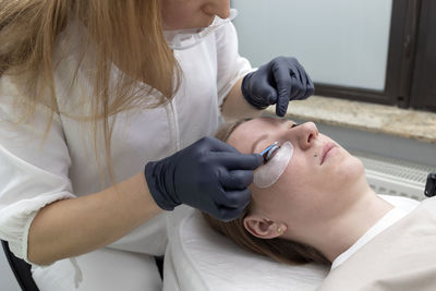 Midsection of doctor examining patient