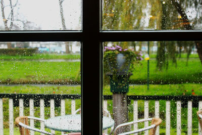 Close-up of wet glass window in rainy season