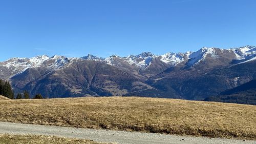 Scenic view of snowcapped mountains against clear blue sky