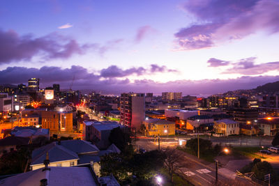 High angle view of illuminated buildings against sky at dusk