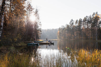 Scenic view of lake in forest against sky