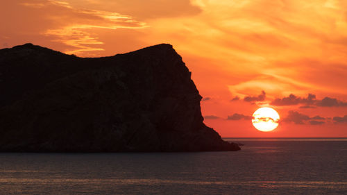 Scenic view of sea against romantic sky at sunset