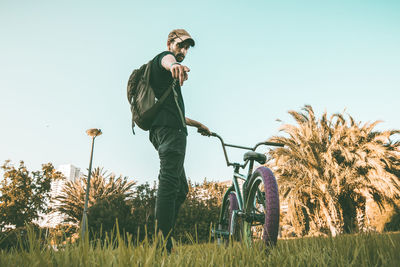 Man with umbrella against clear sky