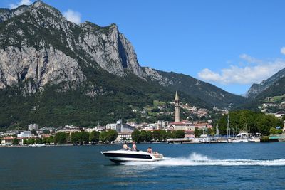 Boats in river with buildings in background