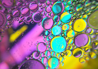 Colorful bubbles abstract background, oil bubbles in transparent liquid backdrop