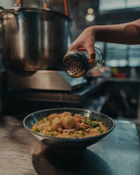 Midsection of person preparing food in kitchen