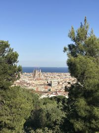 Scenic view of sea and buildings against clear sky
