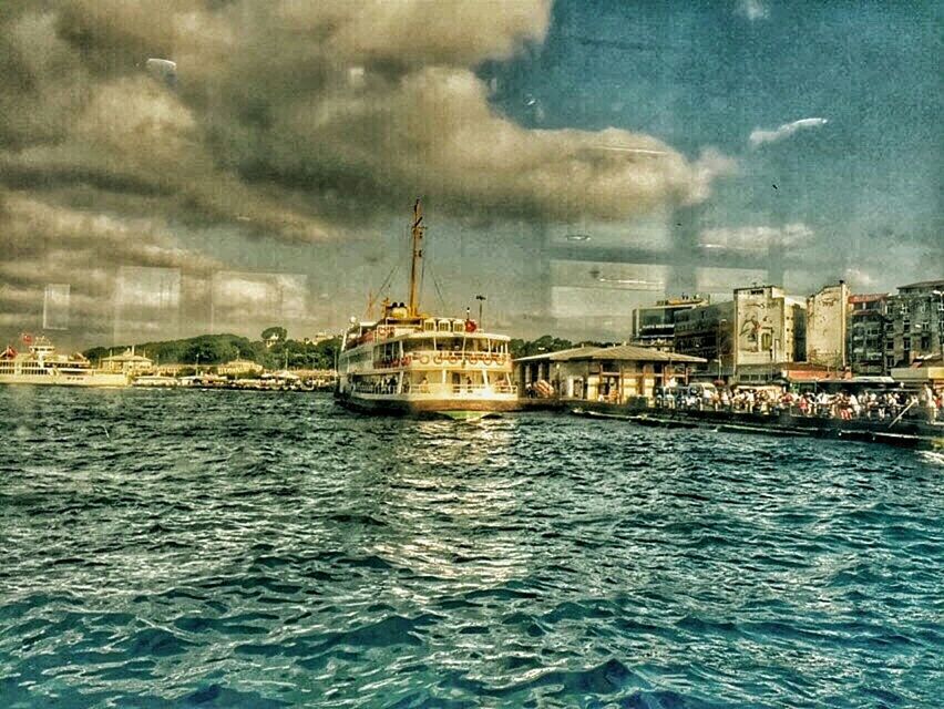 waterfront, water, building exterior, architecture, built structure, sky, nautical vessel, sea, cloud - sky, transportation, cloudy, mode of transport, boat, city, rippled, cloud, ship, river, travel, nature