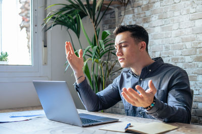 Young man using laptop at office