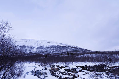 Built structure on snow covered landscape against sky