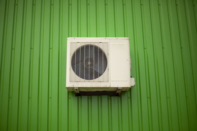 Air conditioning on the green wall of the building. cooling equipment at work. 