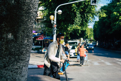 People riding bicycle on street in city