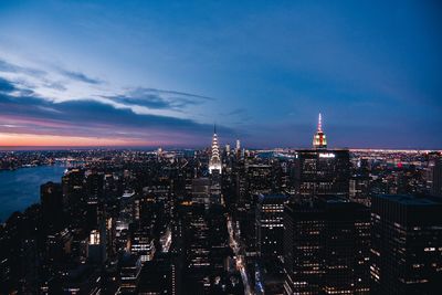 High angle view of city lit up at night