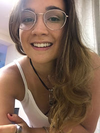 Portrait of smiling young woman using smart phone