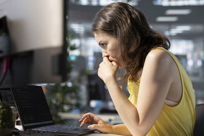 Young woman using laptop at home
