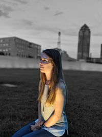 Young woman wearing sunglasses against sky