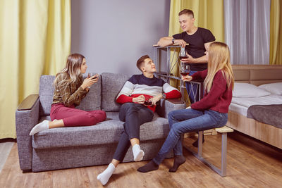 People sitting on sofa at home