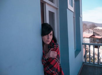 Portrait of woman standing in balcony 