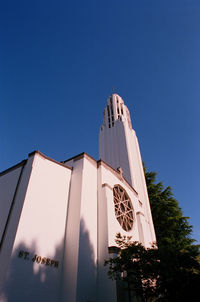 Low angle view of building against clear blue sky