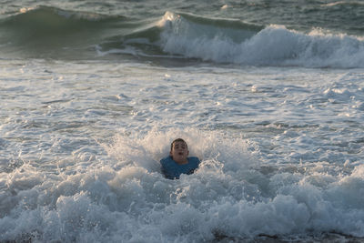 Portrait of young woman swimming in sea