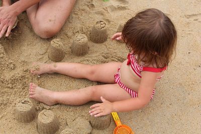 Girl playing on sand at beach